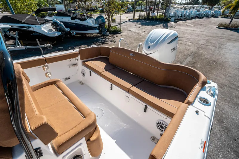 Slide: The Image of 2025 Sea Hunt Ultra 255 SE boat interior with brown seating and Yamaha engine. - 11