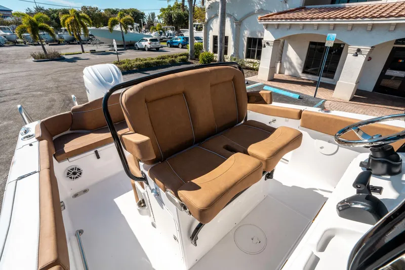 Slide: The Image of 2025 Sea Hunt Ultra 255 SE boat interior with tan seating and steering wheel. - 28