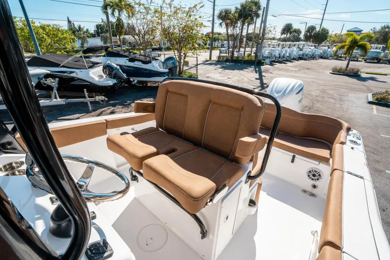 Slide: The Image of 2025 Sea Hunt Ultra 255 SE boat interior with tan seating and steering wheel. - 29