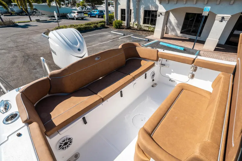Slide: The Image of 2025 Sea Hunt Ultra 255 SE boat interior with tan seating and Yamaha engine. - 12