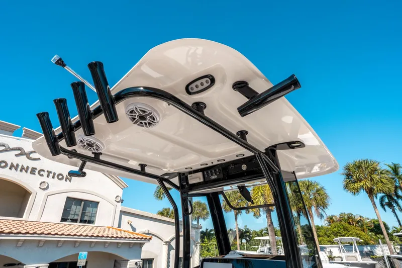 Slide: The Image of 2025 Sea Hunt Ultra 255 SE boat T-top with rod holders and speakers. - 21