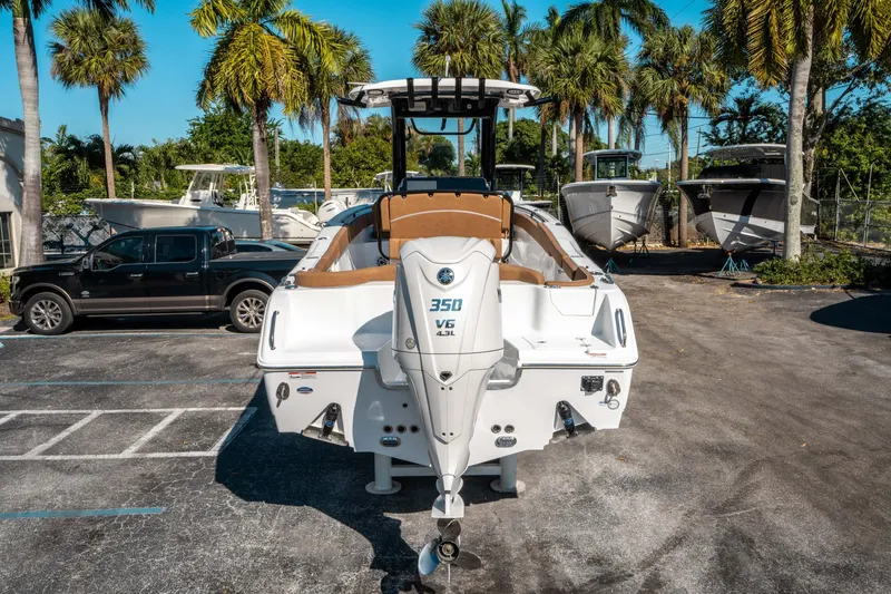 Slide: The Image of 2025 Sea Hunt Ultra 255 SE boat with powerful 350 V6 engine, parked outdoors. - 3