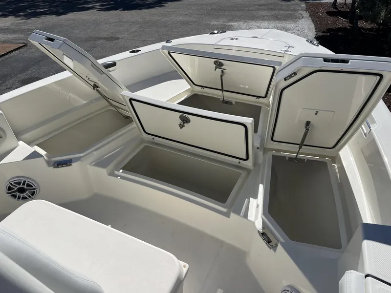 Slide: The Image of 2025 Pathfinder 2400 TRS boat with open storage compartments and seating area. - 16