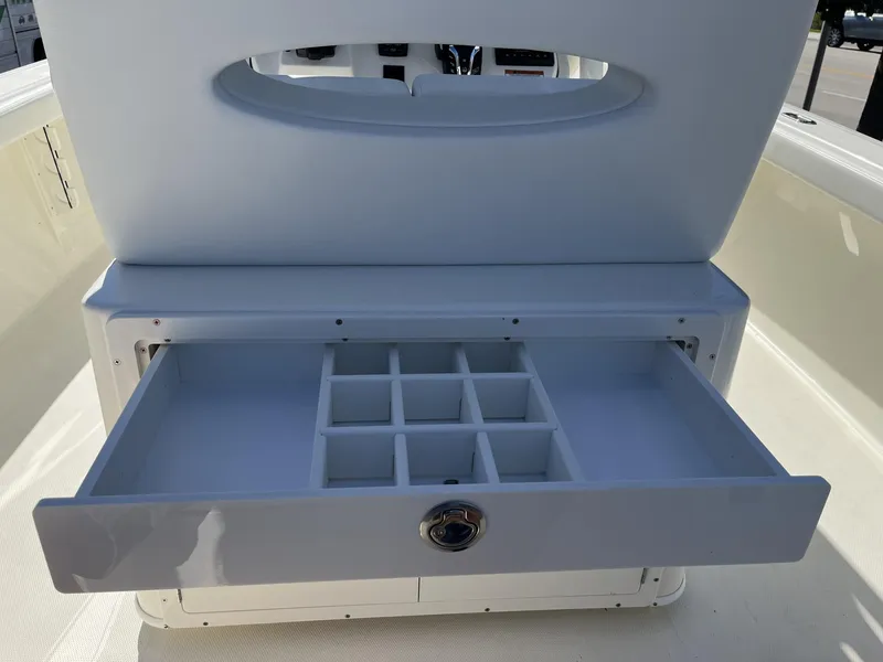 Slide: The Image of Open storage drawer on 2025 Pathfinder 2400 TRS boat, featuring multiple compartments. - 32