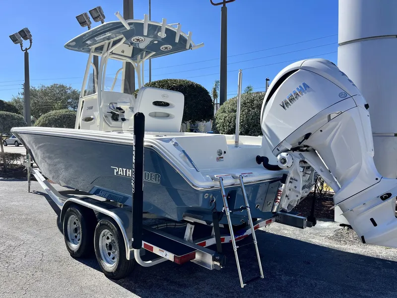 Slide: The Image of 2025 Pathfinder 2400 TRS boat with Yamaha engine on trailer, outdoor display. - 4