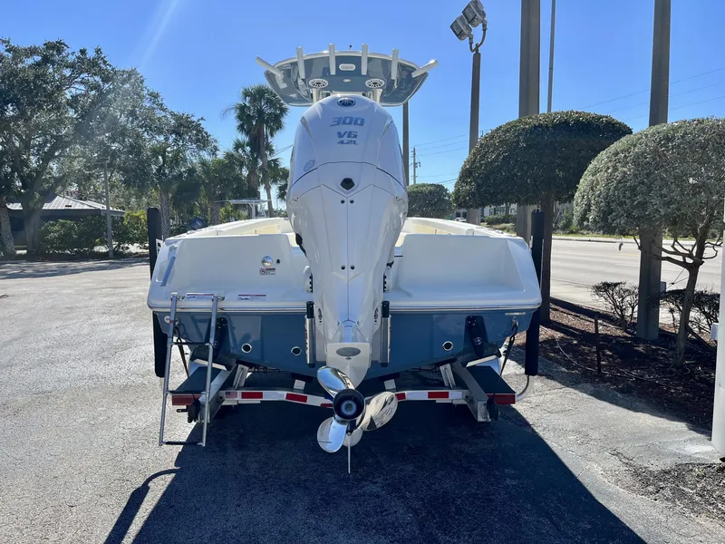 Slide: The Image of 2025 Pathfinder 2400 TRS boat with V6 engine on trailer, parked outdoors. - 5