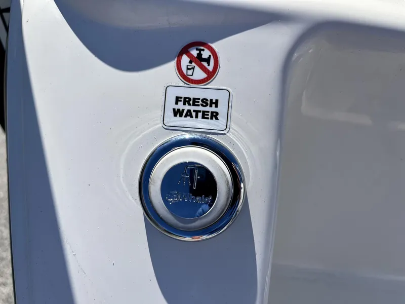 Slide: The Image of Fresh water access on 2025 Pathfinder 2400 TRS boat, labeled with caution sign. - 9