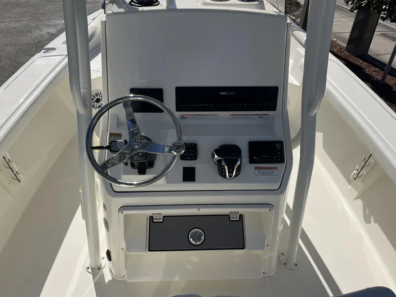 Slide: The Image of 2025 Pathfinder 2400 TRS boat console with steering wheel and controls. - 11