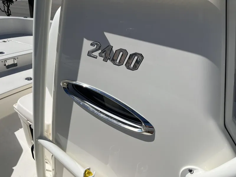 Slide: The Image of 2025 Pathfinder 2400 TRS boat detail with chrome accents and model number. - 14