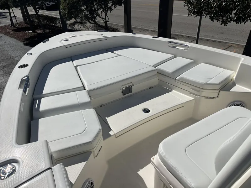 Slide: The Image of 2025 Pathfinder 2400 TRS boat interior with cushioned seating and storage compartments. - 19