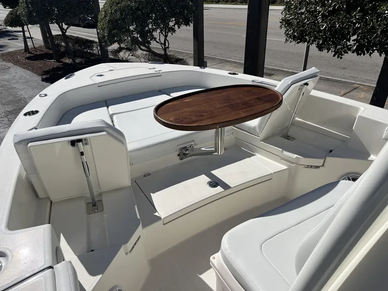 Slide: The Image of 2025 Pathfinder 2400 TRS boat interior with seating and wooden table. - 20