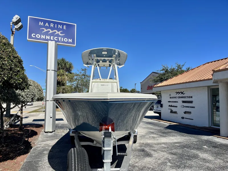 Slide: The Image of 2025 Pathfinder 2400 TRS boat at Marine Connection dealership under clear blue sky. - 3