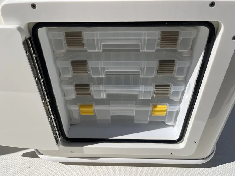 Slide: The Image of Storage compartment with organized tackle boxes on a 2025 Pathfinder 2400 TRS boat. - 31