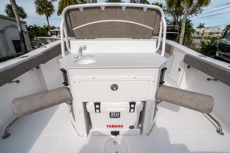 Slide: The Image of 2025 Sea Hunt Ultra 275 SE boat interior with seating and sink. - 16
