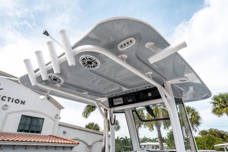 Slide: The Image of 2025 Sea Hunt Ultra 275 SE boat with T-top and rod holders, outdoor setting. - 20