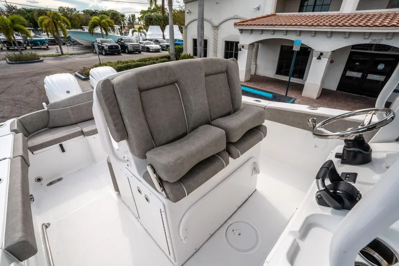 Slide: The Image of 2025 Sea Hunt Ultra 275 SE boat interior with cushioned seating and steering wheel. - 28
