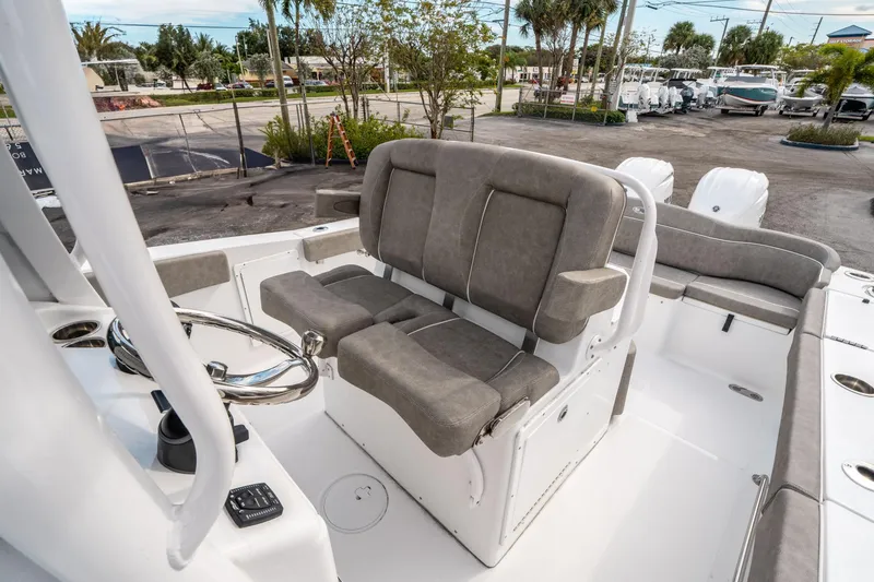 Slide: The Image of 2025 Sea Hunt Ultra 275 SE boat interior with gray seating and steering wheel. - 30