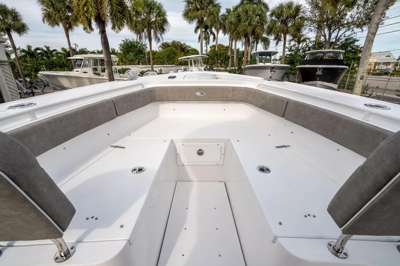 Slide: The Image of 2025 Sea Hunt Ultra 275 SE boat interior with spacious seating and palm trees in the background. - 38