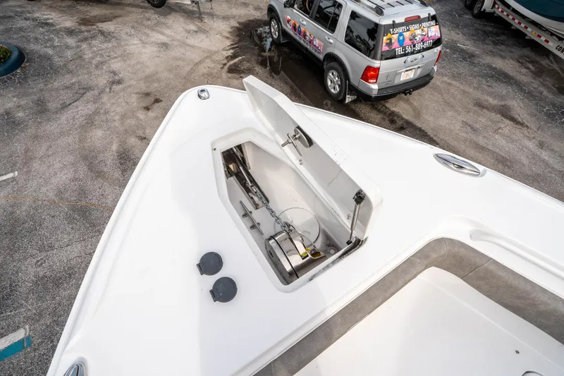 Slide: The Image of 2025 Sea Hunt Ultra 275 SE boat with open storage compartment on deck. - 42