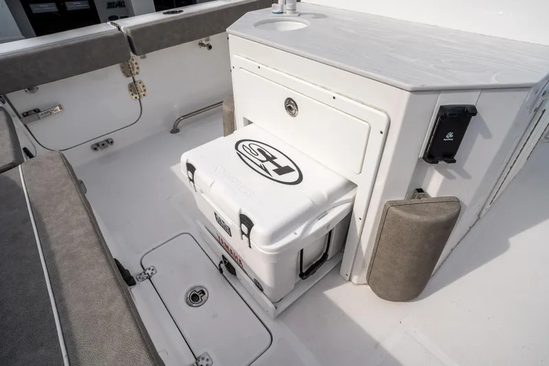 Slide: The Image of 2025 Sea Hunt Ultra 275 SE boat interior with storage and seating area. - 17