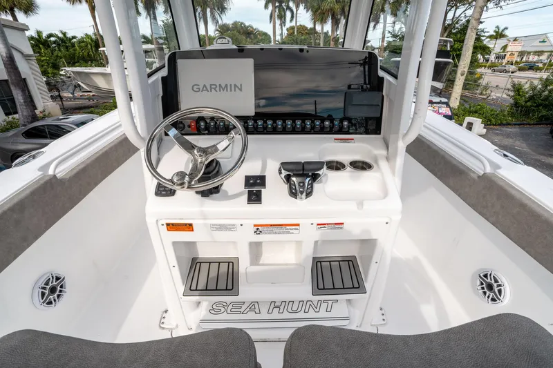 Slide: The Image of 2025 Sea Hunt Ultra 275 SE boat console with Garmin navigation system and steering wheel. - 21