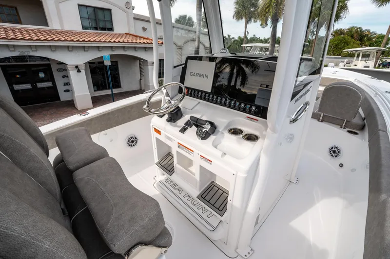 Slide: The Image of 2025 Sea Hunt Ultra 275 SE boat interior with Garmin navigation system and comfortable seating. - 22