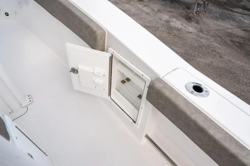 Slide: The Image of 2025 Sea Hunt Ultra 275 SE boat interior with open storage compartment. - 25