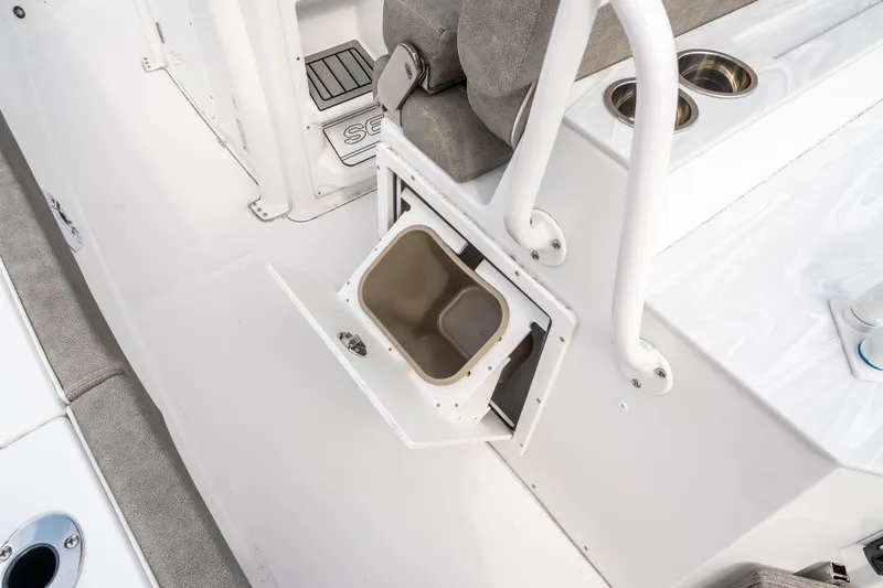 Slide: The Image of 2025 Sea Hunt Ultra 275 SE boat interior with storage compartment and seating. - 26