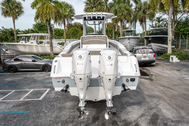 Slide: The Image of 2025 Sea Hunt Ultra 275 SE boat with dual engines, parked outdoors. - 3