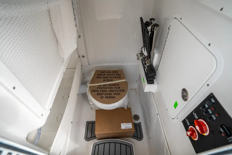 Slide: The Image of Interior of 2025 Sea Hunt Ultra 275 SE boat, featuring storage and control panel. - 36