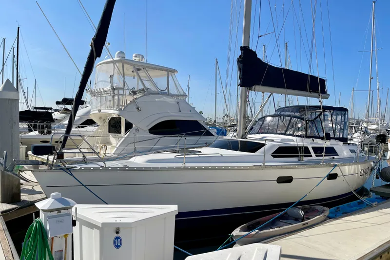 Slide: The Image of 1998 Hunter Passage 42 sailboat docked at marina under clear blue sky. - 0