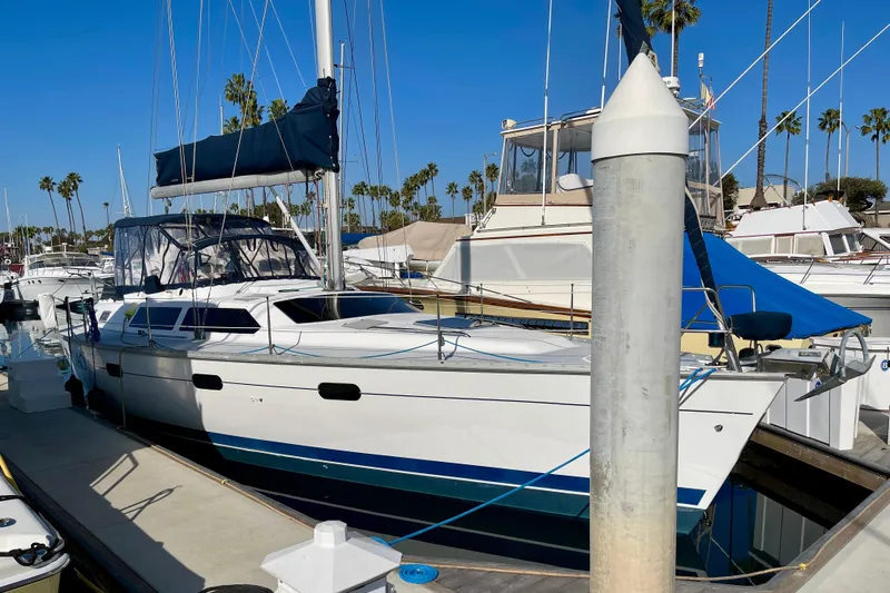 Slide: The Image of 1998 Hunter Passage 42 sailboat docked at marina with clear blue sky. - 1