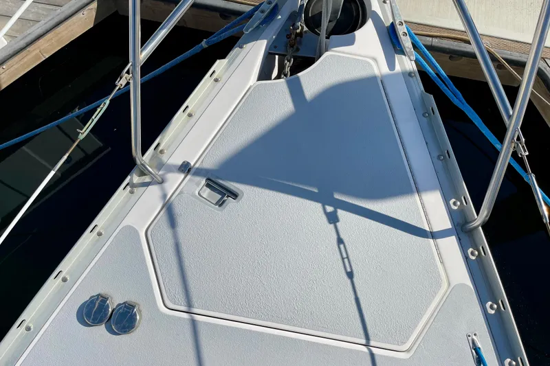 Slide: The Image of Deck of 1998 Hunter Passage 42 sailboat with stainless steel fittings and blue ropes. - 13