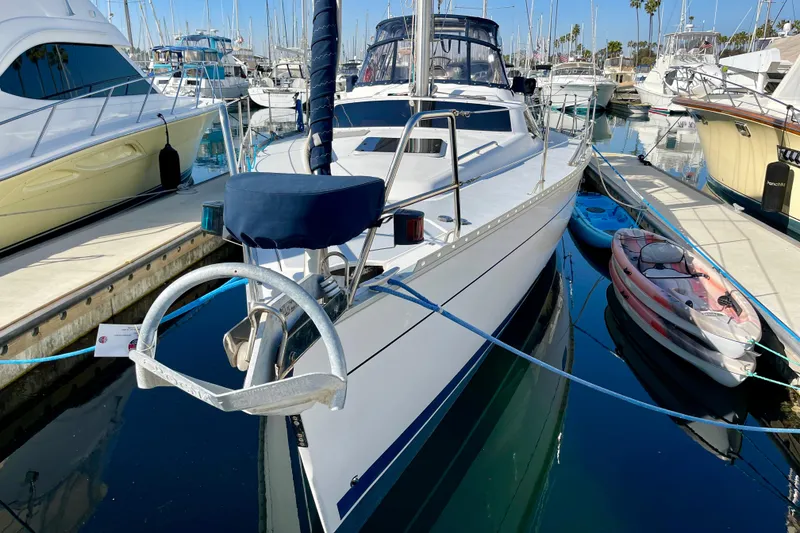 Slide: The Image of Sailboat Hunter Passage 42, 1998 model, docked in a marina with other boats. - 2