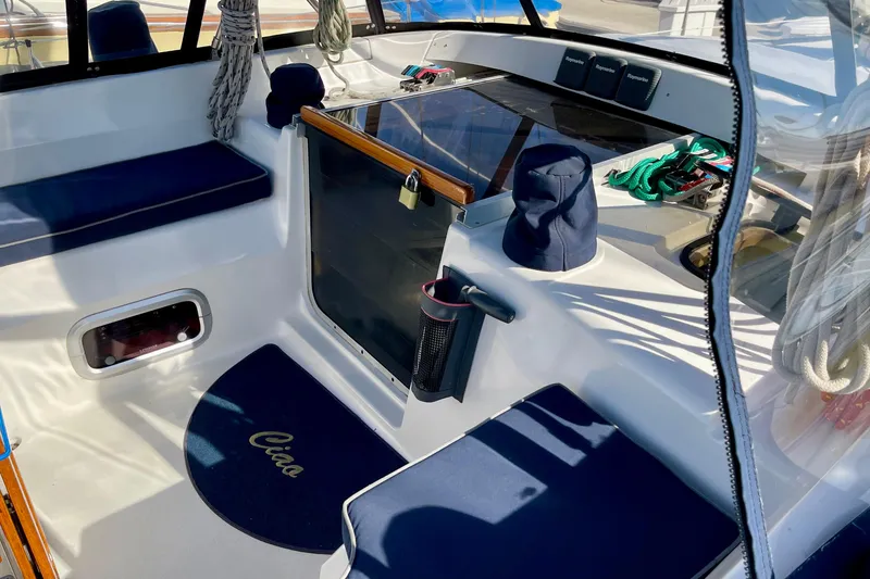 Slide: The Image of Cockpit of 1998 Hunter Passage 42 sailboat with blue seating and nautical decor. - 22