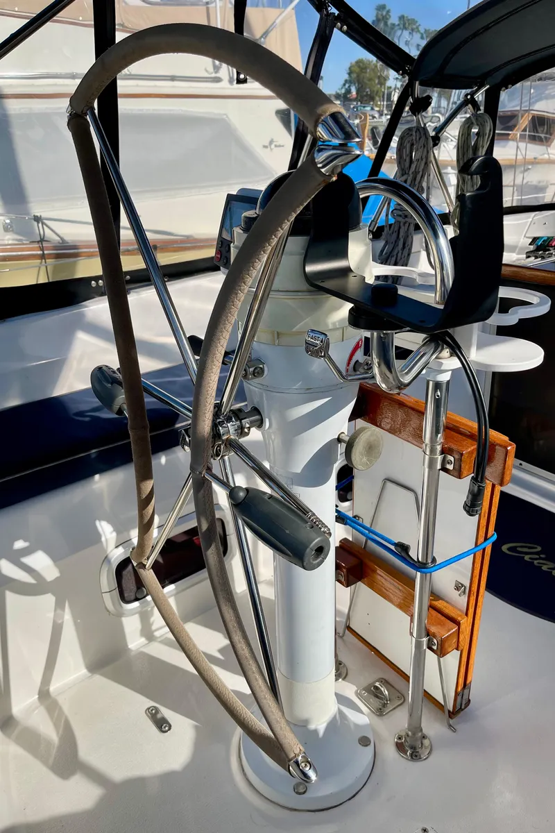 Slide: The Image of Steering wheel of a 1998 Hunter Passage 42 sailboat, featuring a modern helm design. - 25