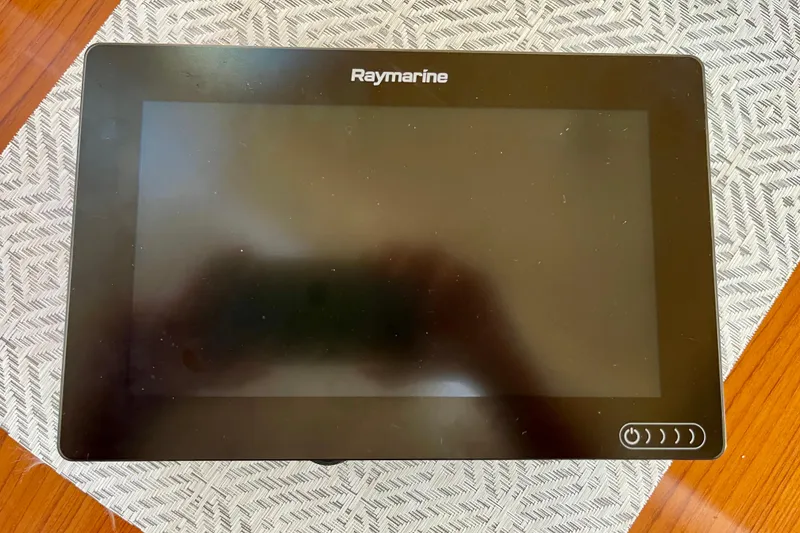 Slide: The Image of Raymarine navigation display on Hunter Passage 42 yacht, 1998 model, placed on a patterned surface. - 28