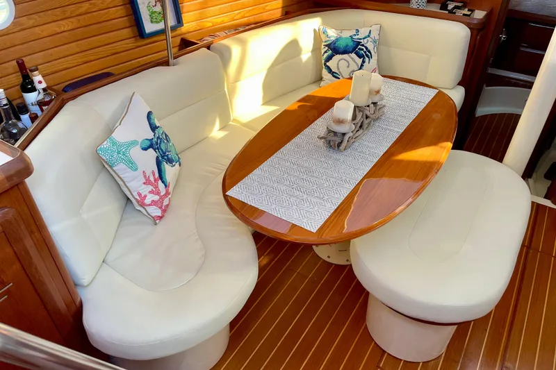 Slide: The Image of Cozy interior of 1998 Hunter Passage 42 yacht with elegant seating and decorative pillows. - 33