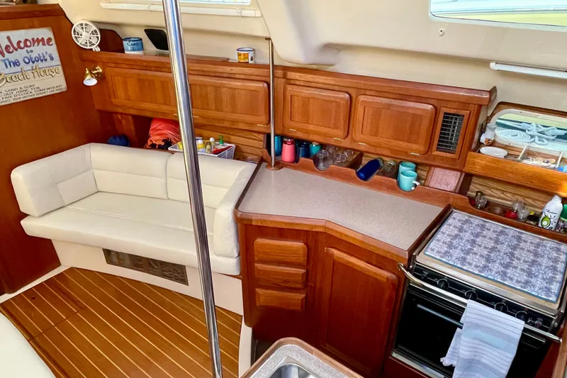 Slide: The Image of Interior of 1998 Hunter Passage 42 yacht with wooden cabinetry and cozy seating area. - 34