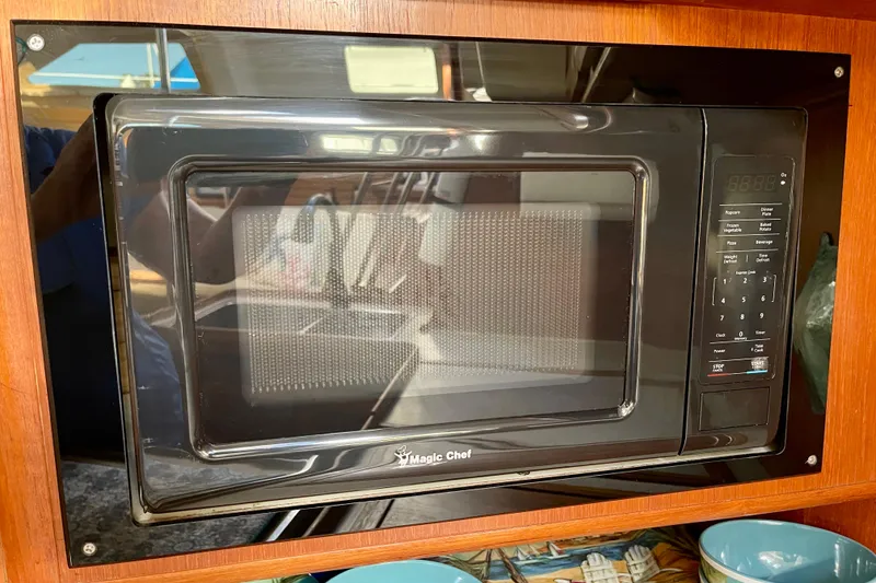 Slide: The Image of Microwave oven in a 1998 Hunter Passage 42 yacht kitchen, with wooden cabinetry. - 39
