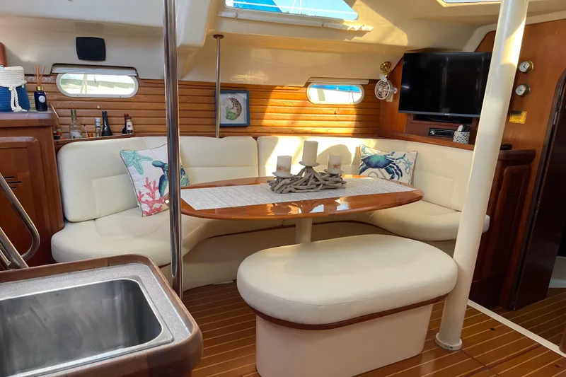 Slide: The Image of 1998 Hunter Passage 42 yacht interior with cozy seating, wooden accents, and modern amenities. - 43