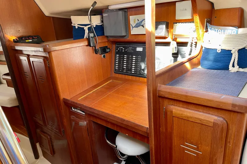 Slide: The Image of 1998 Hunter Passage 42 yacht interior with wooden cabinetry and navigation station. - 45