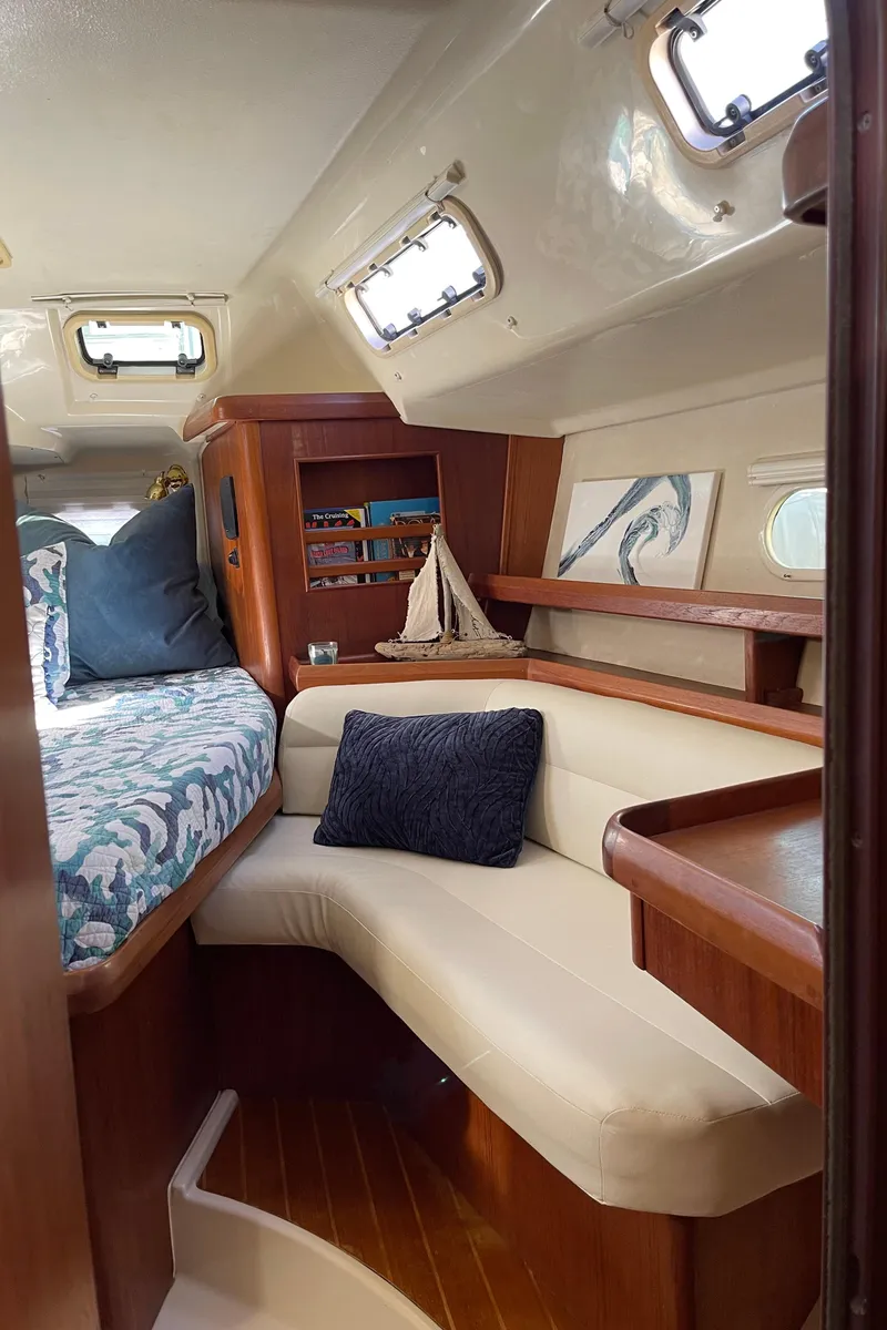 Slide: The Image of Interior of 1998 Hunter Passage 42 sailboat with cozy seating and nautical decor. - 46