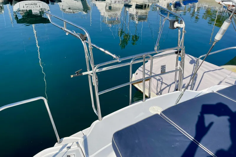 Slide: The Image of 1998 Hunter Passage 42 sailboat deck with railing, docked in a marina. - 8