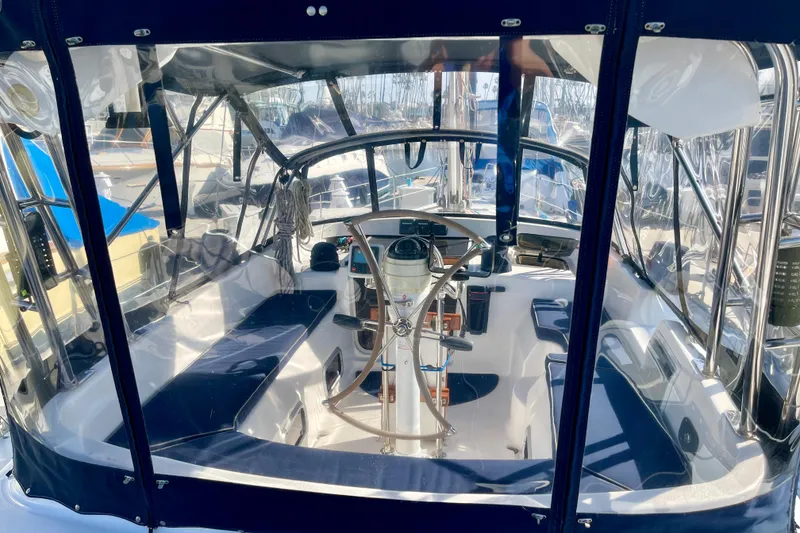 Slide: The Image of Cockpit of 1998 Hunter Passage 42 sailboat with steering wheel and seating. - 9