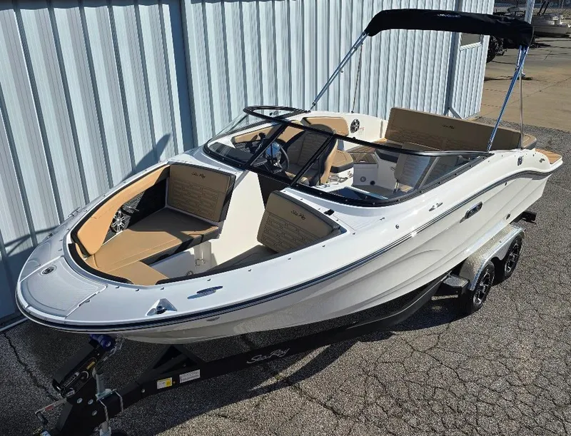 The Image of 2025 Sea Ray SPX 210 BR boat with sleek design and tan interior on trailer. - 0