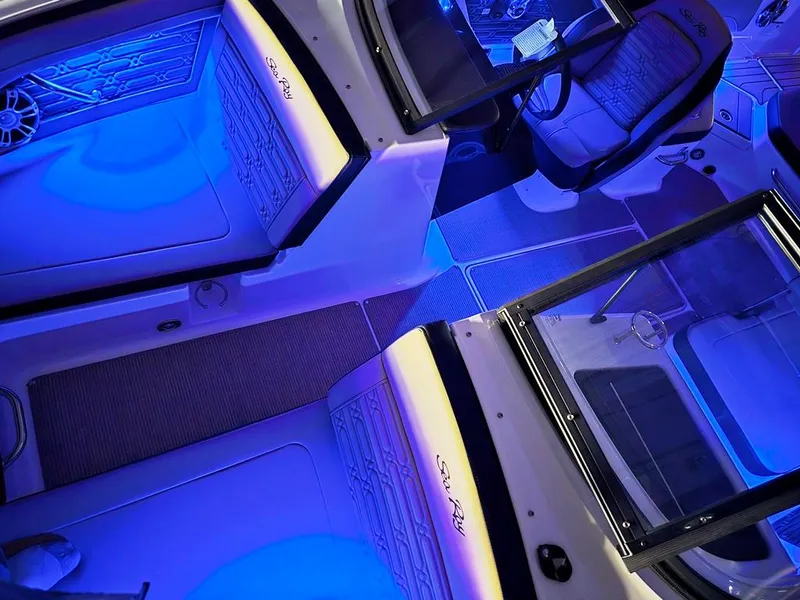 Slide: The Image of 2025 Sea Ray SPX 210 BR interior with blue ambient lighting. - 26