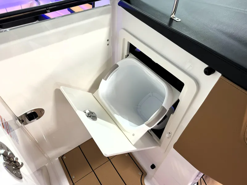 Slide: The Image of 2025 Chaparral 267 SSX boat with built-in storage compartment and removable bin. - 12