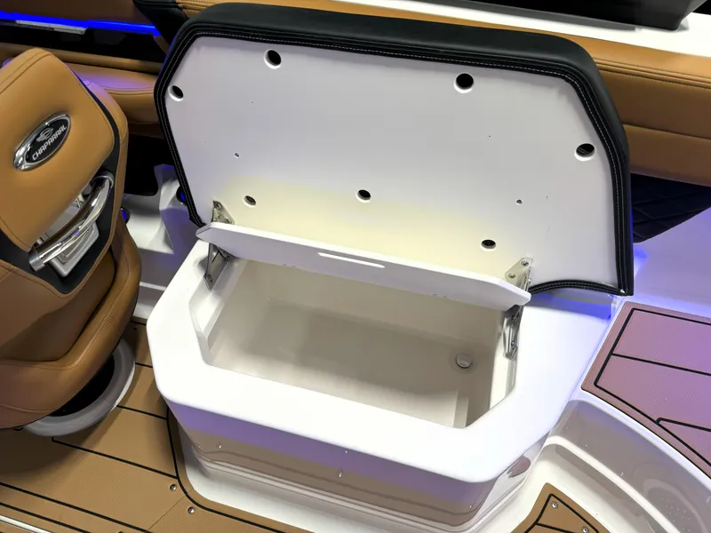Slide: The Image of Open storage compartment on 2025 Chaparral 267 SSX boat, featuring tan and white interior. - 14