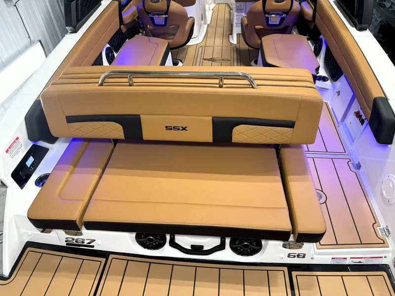 Slide: The Image of 2025 Chaparral 267 SSX boat interior with tan leather seating and modern design. - 16